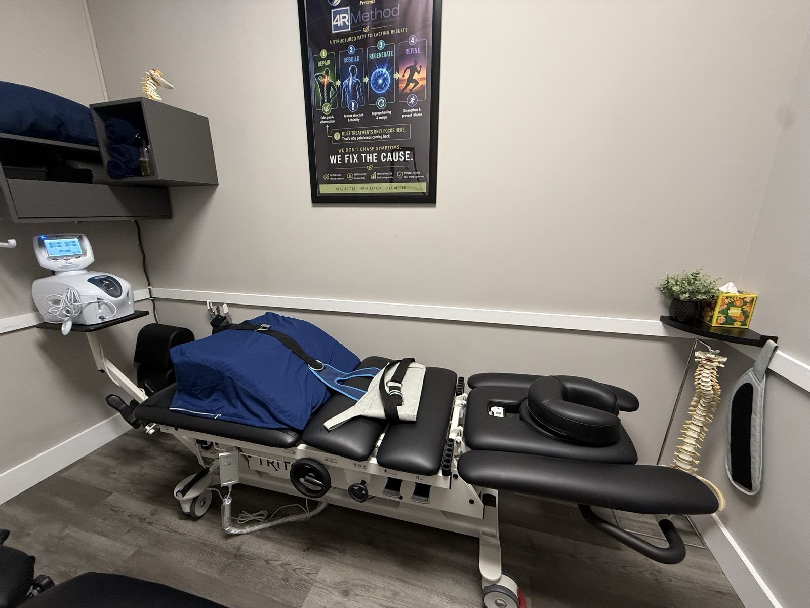 The practice's spinal decompression traction table with harness straps and cervical cushion in a treatment room at Lovejoy Chiro & Med Spa in Allen, TX