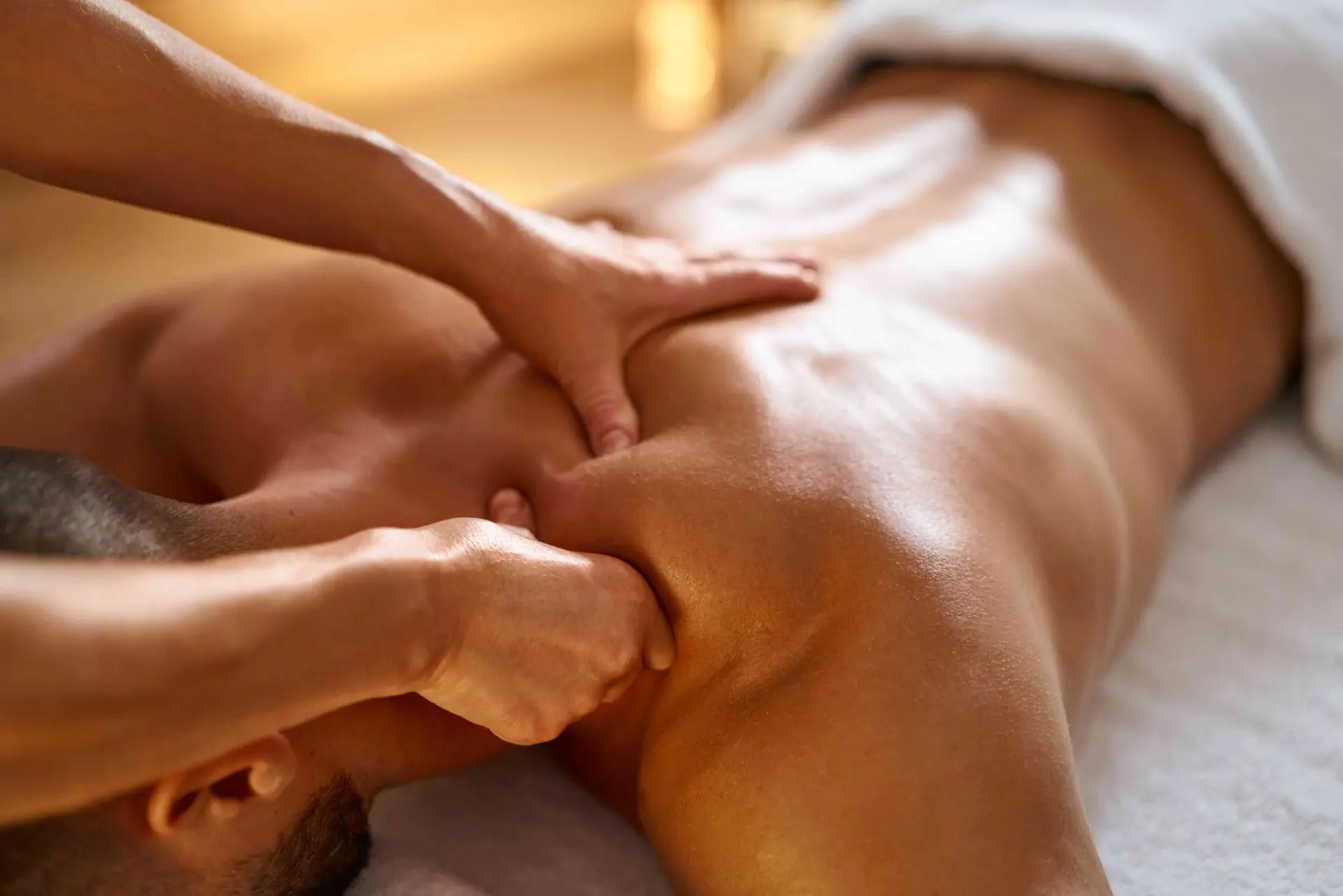 Massage therapist working a client's neck and shoulder during a massage therapy session at Lovejoy Chiro & Med Spa in Allen, TX